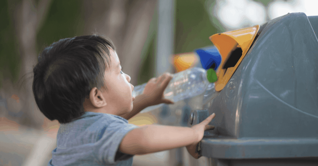 Toddler recycling plastic bottle