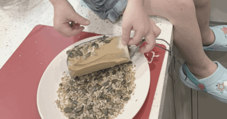 child making homemade recycled bird feeder