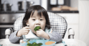child eating broccoli