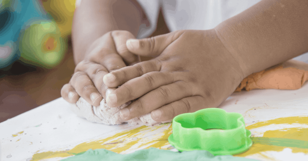 Toddler making play dough