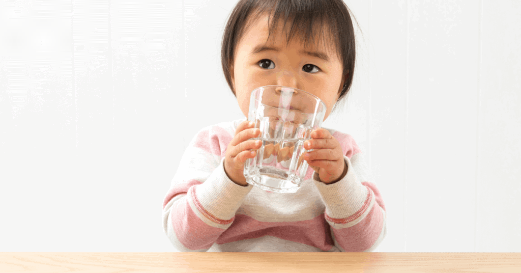 toddler drinking from glass