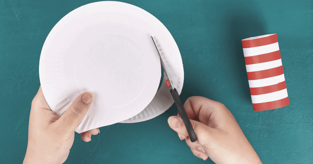 child cutting paper plate