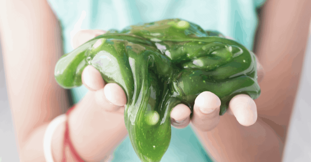 child holding green slime