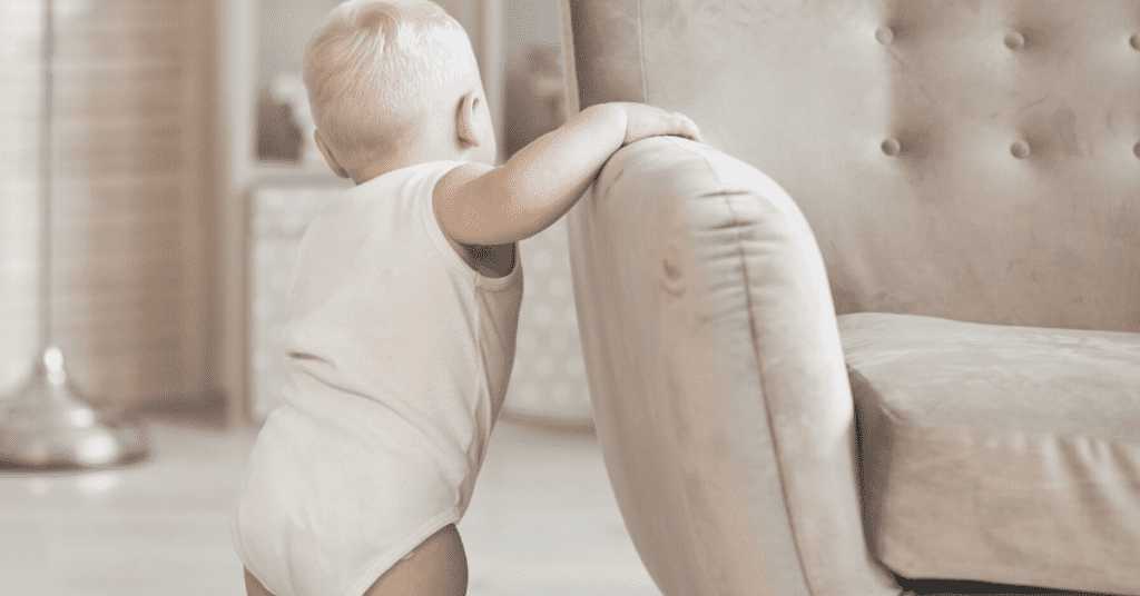 Baby standing up holding chair