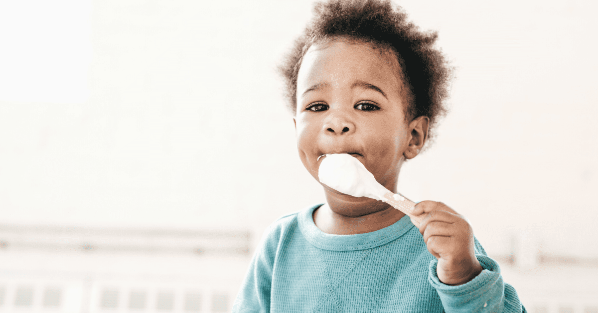 toddler eating with spoon