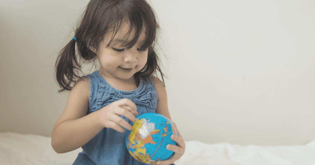 toddler holding globe