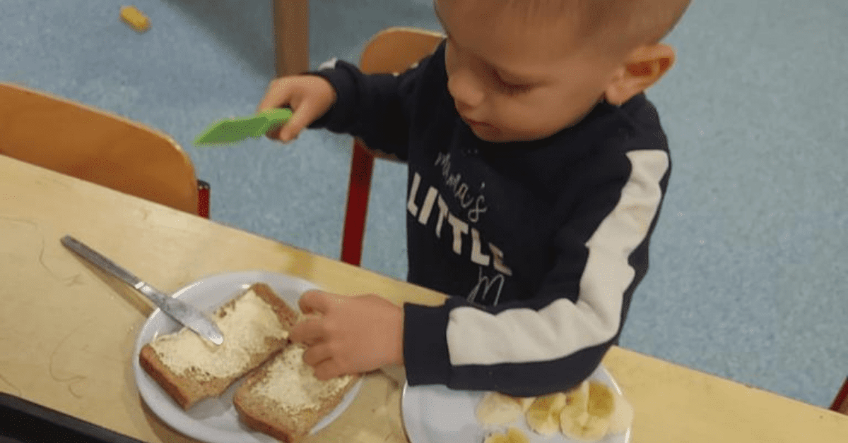 child eating breakfast at nursery