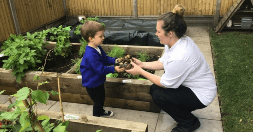 chef and child growing vegetables at Horley nursery
