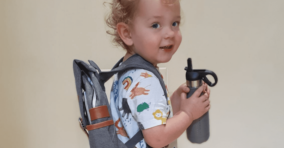 child with fennies rucksack and bottle