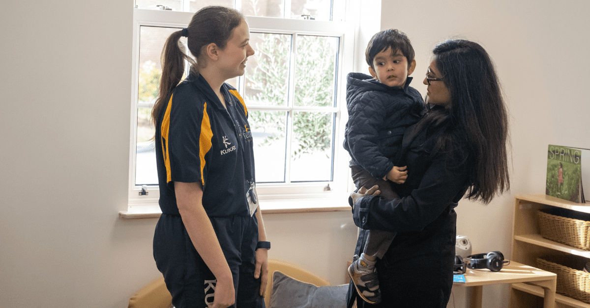 parent and child talking to nursery practitioner