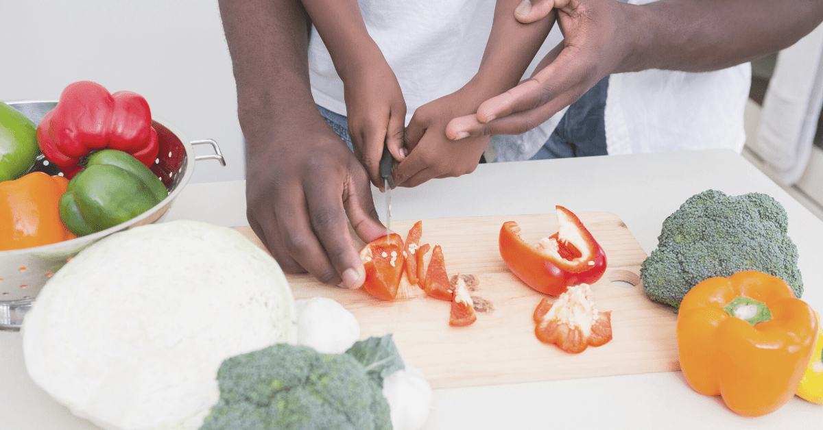 parent and child chopping peppers