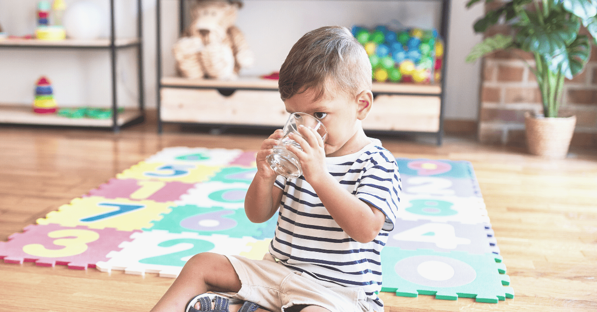 Toddler drinking glass of water