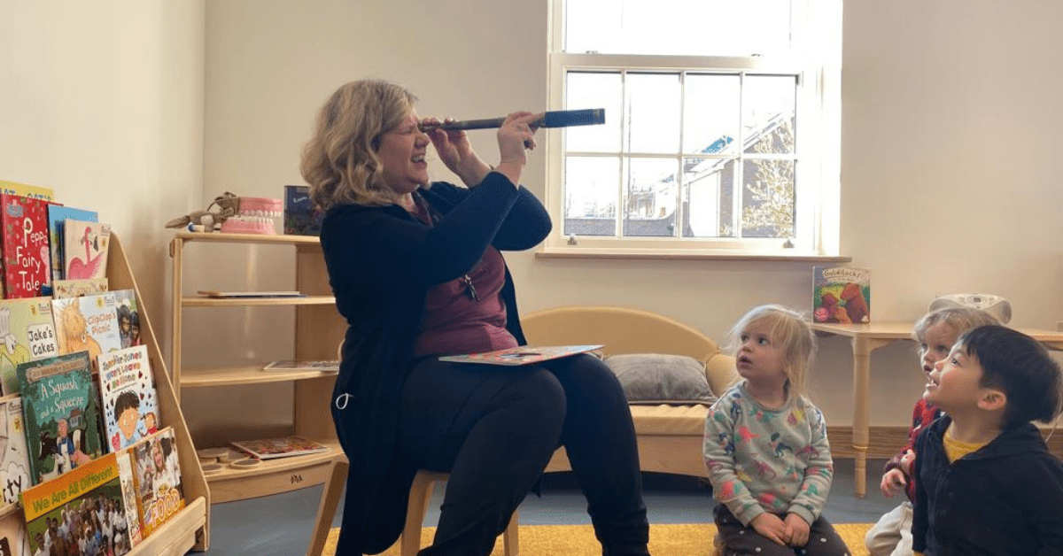 childcare practitioner in nursery room