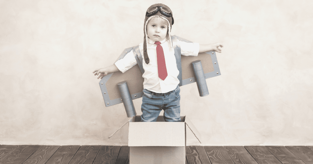 child in cardboard box rocket