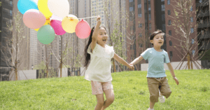 children running with balloons
