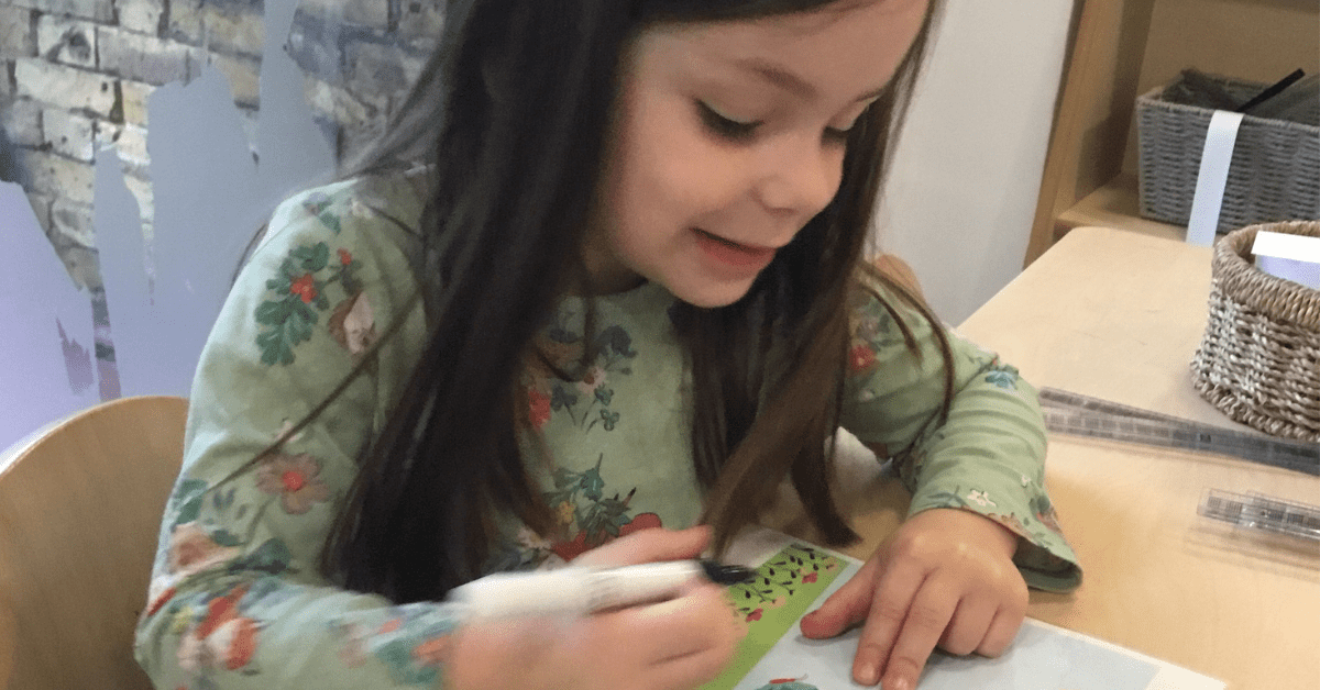 child writing in nursery