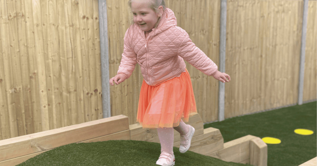 child running over hill in nursery garden