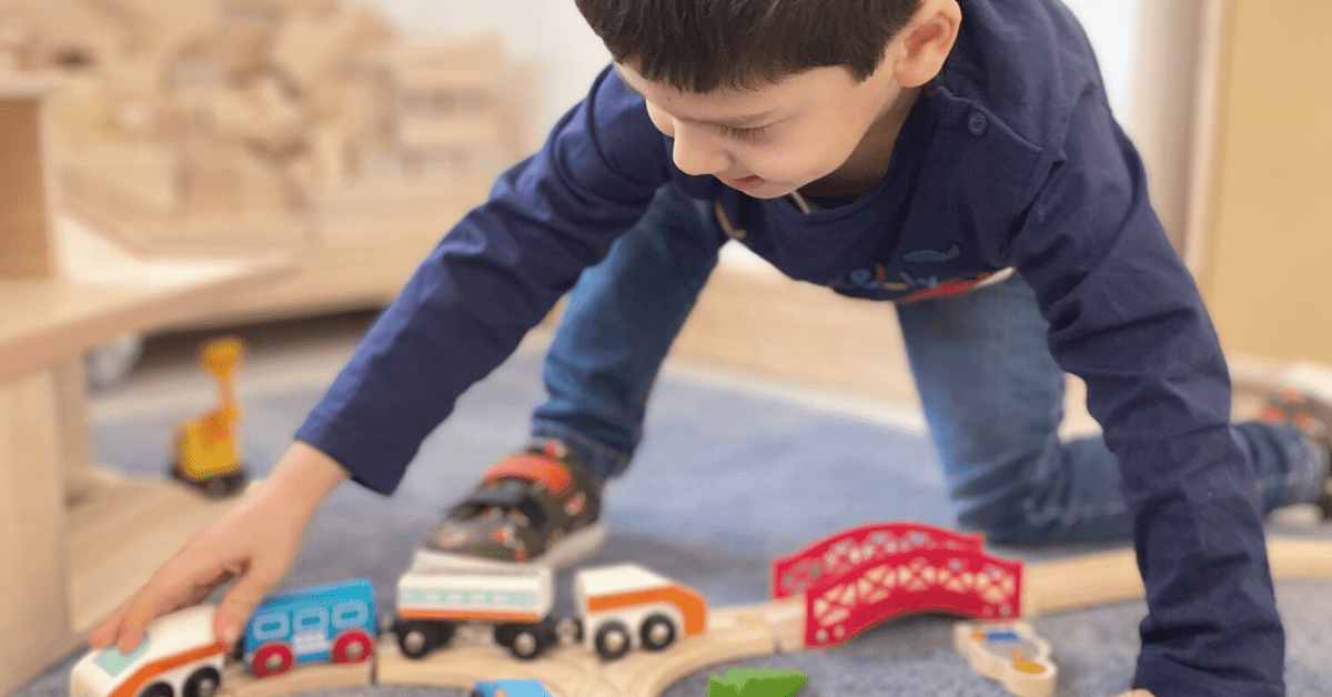 child playing with toy car in nursery