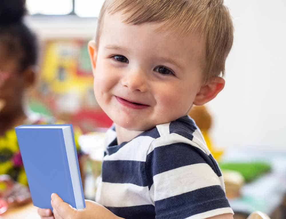 fennies nursery little boy holding book