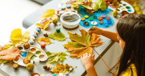children painting autumn leaves