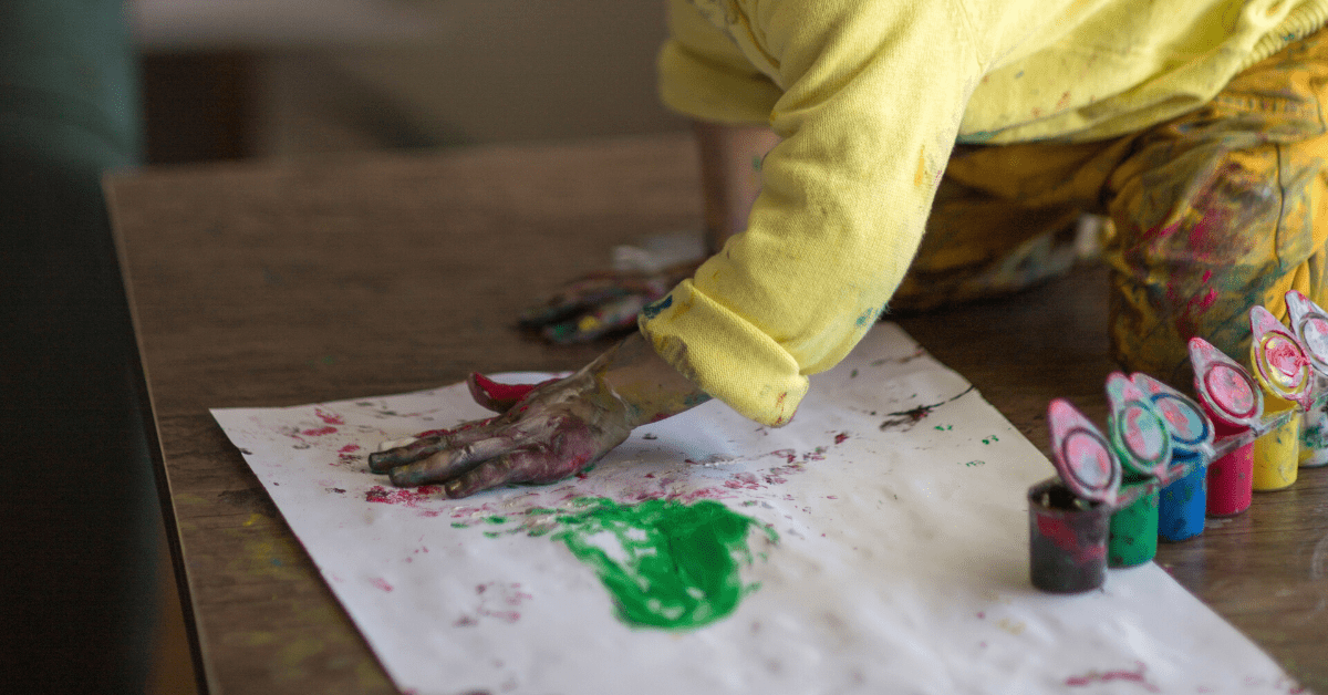 child painting handprint picture