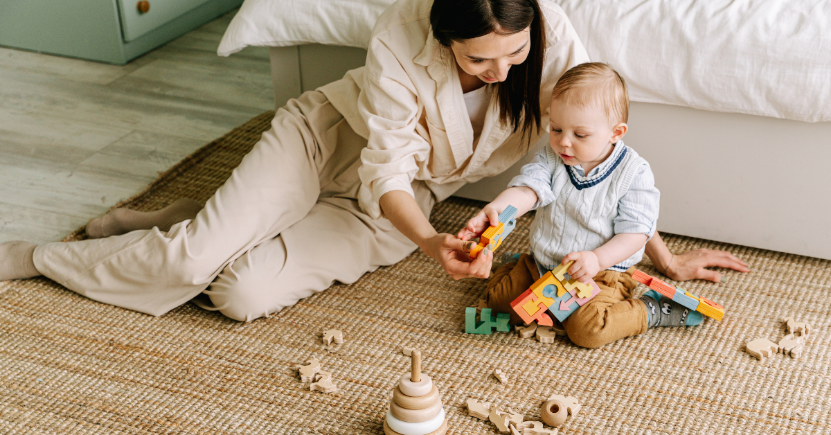 parent and child playing with wooden blocks