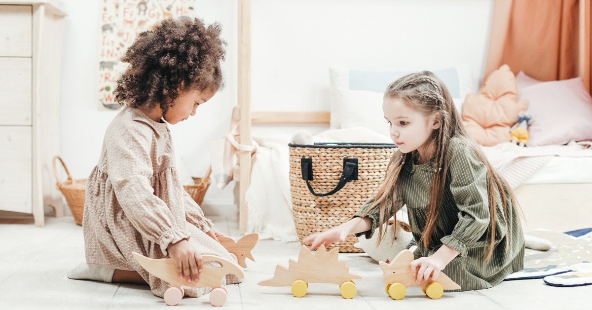 two children playing with wooden toys