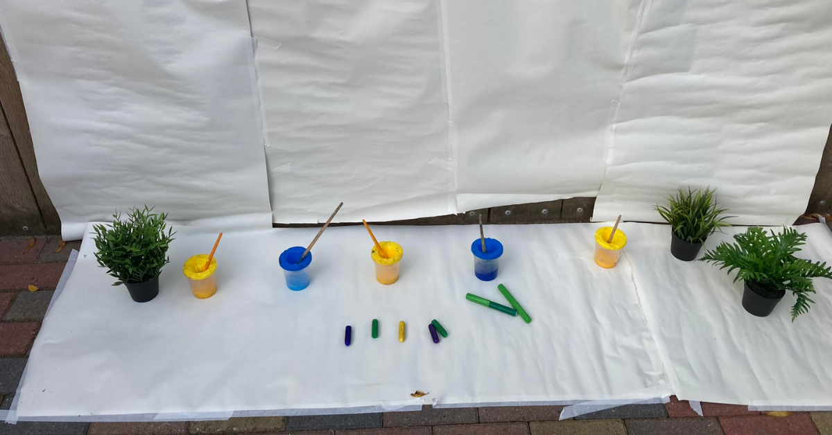 outdoor large paper and paint mark making activity