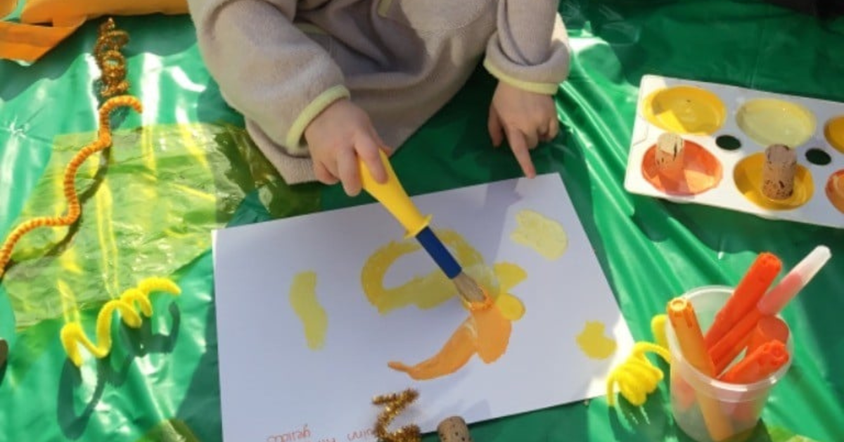 child painting picture using paintbrush